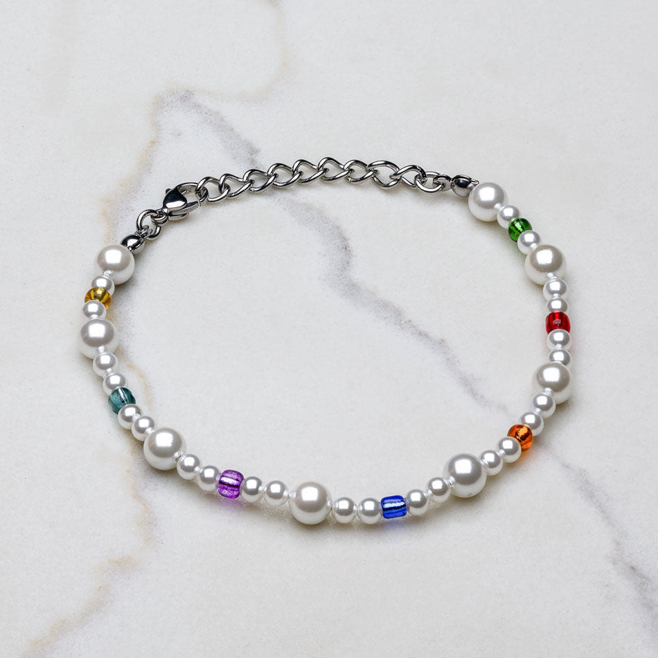 Our Multicolored Asymmetric Pearl Bracelet has been crafted using different sized polished white pearls, colored beads and the finest silver hardware to hold it all together.