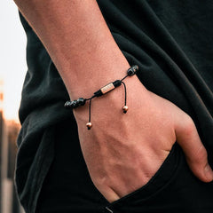 Black Stone Bead Bracelet - Our Black Stone Bead Bracelet Features Natural Stones, Waxed Cord and Brushed Rose Gold Steel Hardware. A Beautiful Addition to any Collection.