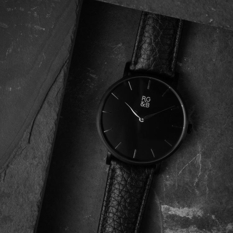 Black Minimal Watch - Explore our Classic Minimal Watch in All Black. Featuring a Brushed Black Case, Gunmetal Hands & Hour Markers, a Black Dial and a Black Leather Strap.