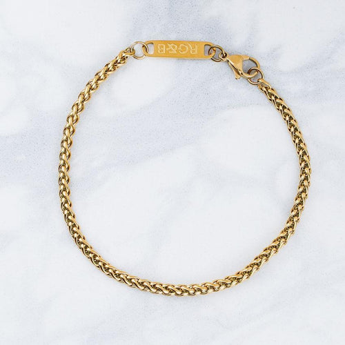 Our Gold Wheat Chain Bracelet features our premium gold wheat chain and signature polished gold plate, engraved with RG&B.