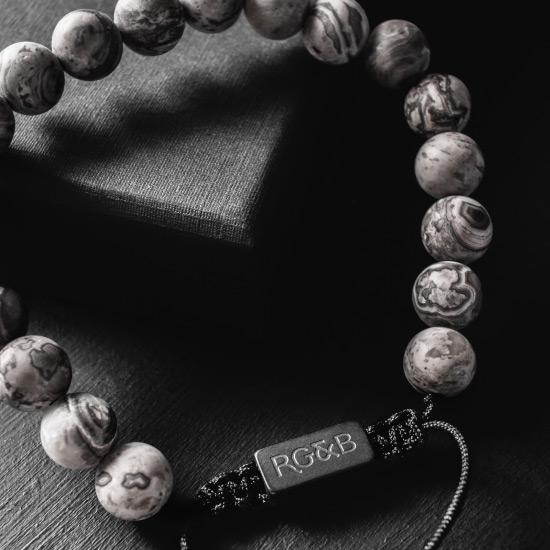 Grey Jasper Bead Bracelet - Our Grey Jasper Bead Bracelet Features Natural Stones, Waxed Cord and Brushed Black Steel Hardware. A Beautiful Addition to any Collection.