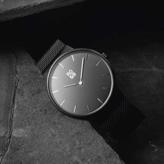 Minimal Black Watch - Our Minimal Black Watch Features a Brushed Black Stainless Steel Case and Strap, Gunmetal Hands and Hour Markers Along with our Signature Logo.