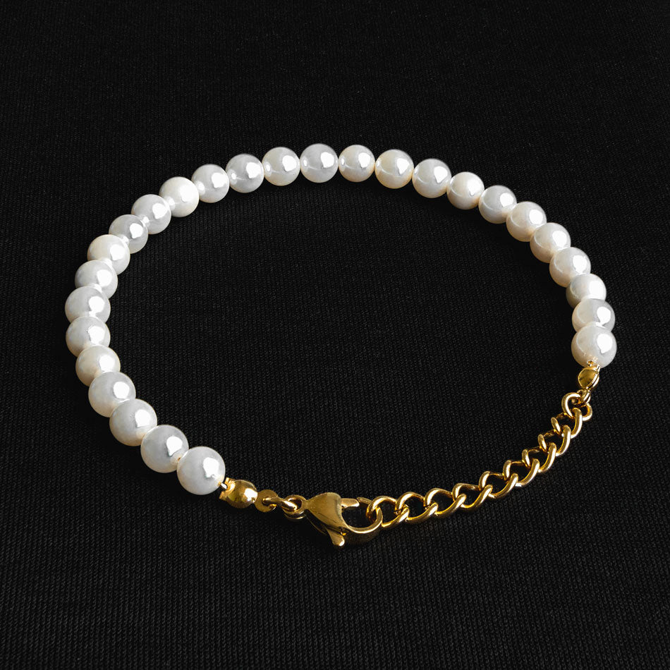 Our Pearl Bracelet with 24KT Gold Plated Hardware has been crafted using polished white pearls, along with the finest gold chain to hold it all together.