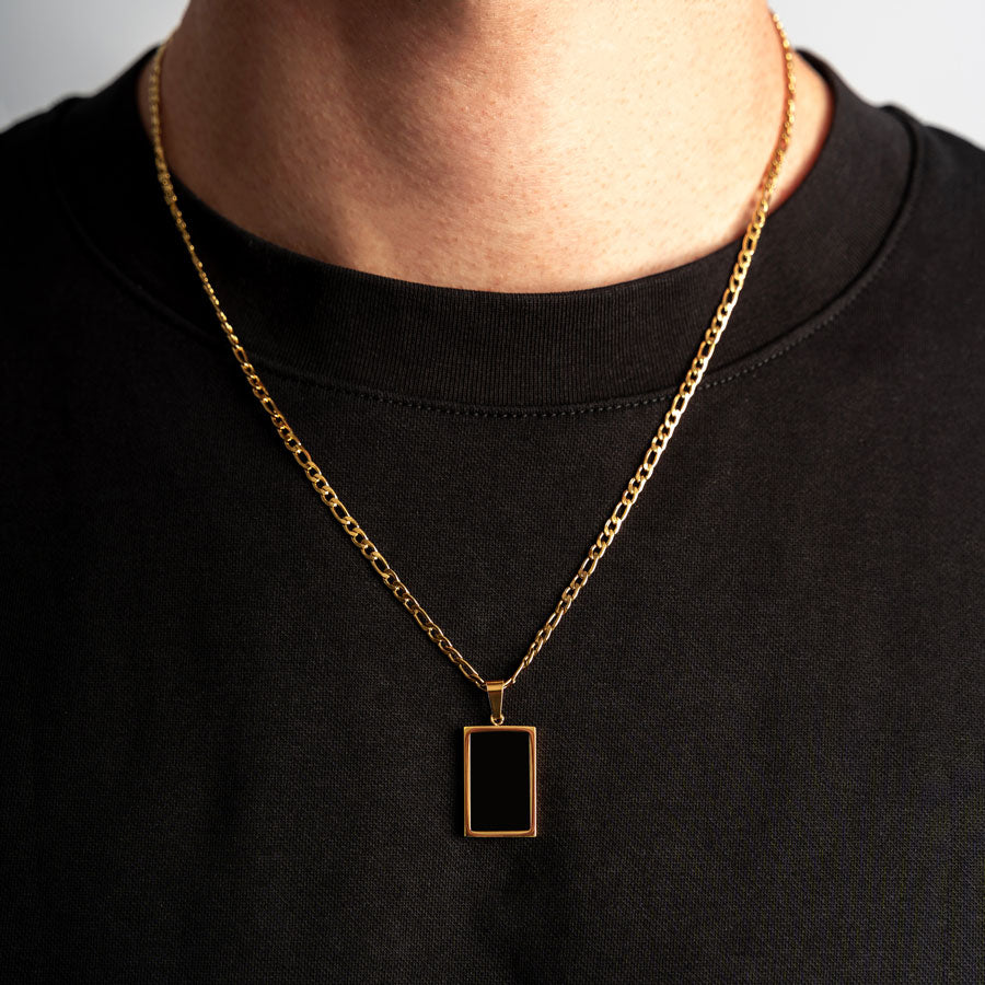 Our Premium Rectangle Pendant paired with our Signature Figaro Chain is the perfect touch of Gold & Black.
