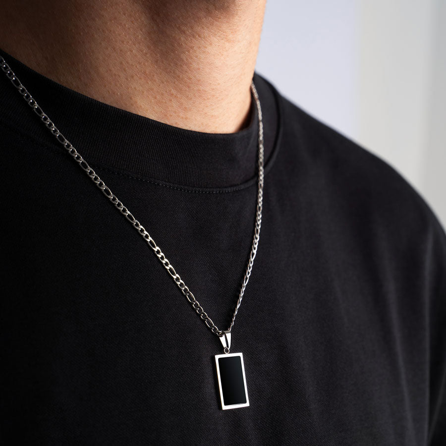 Our Premium Rectangle Pendant paired with our Signature Figaro Chain is the perfect touch of Silver & Black.