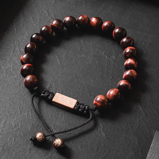 Red Tiger Eye Bead Bracelet - Our Red Tiger Eye Bead Bracelet Features Natural Stones, Waxed Cord and Brushed Rose Gold Steel Hardware. A Beautiful Addition to any Collection.
