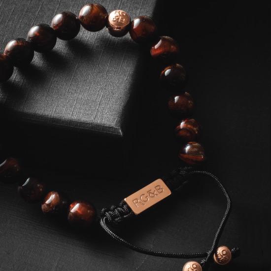 Premium Red Tiger Eye Bead Bracelet - Our Premium Red Tiger Eye Bead Bracelet Features Natural Stones, Waxed Cord and Polished Rose Gold Steel Hardware. A Beautiful Addition to any Collection.