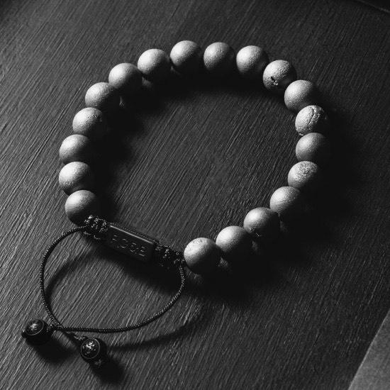 Smile Agate Bead Bracelet - Our Smile Agate Bead Bracelet Features Natural Stones, Waxed Cord and Brushed Black Steel Hardware. A Beautiful Addition to any Collection.