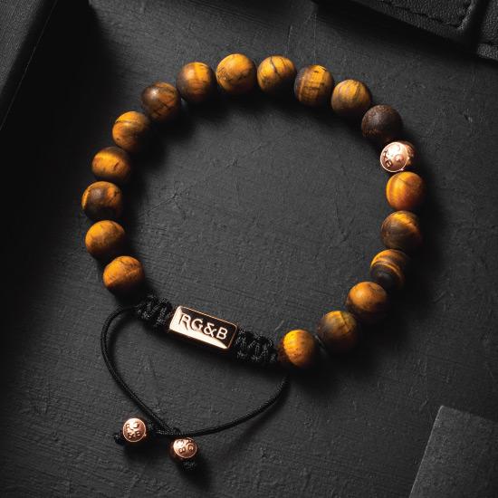 Premium Tiger's Eye Bead Bracelet - Our Premium Tiger’s Eye Bead Bracelet Features Natural Stones, Waxed Cord and Polished Rose Gold Steel Hardware. A Beautiful Addition to any Collection.